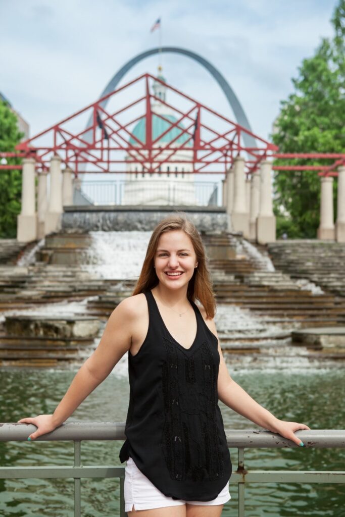 A person standing in front of a fountain